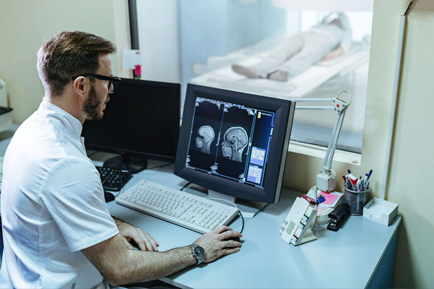 An MRI tech looking at a brain scan