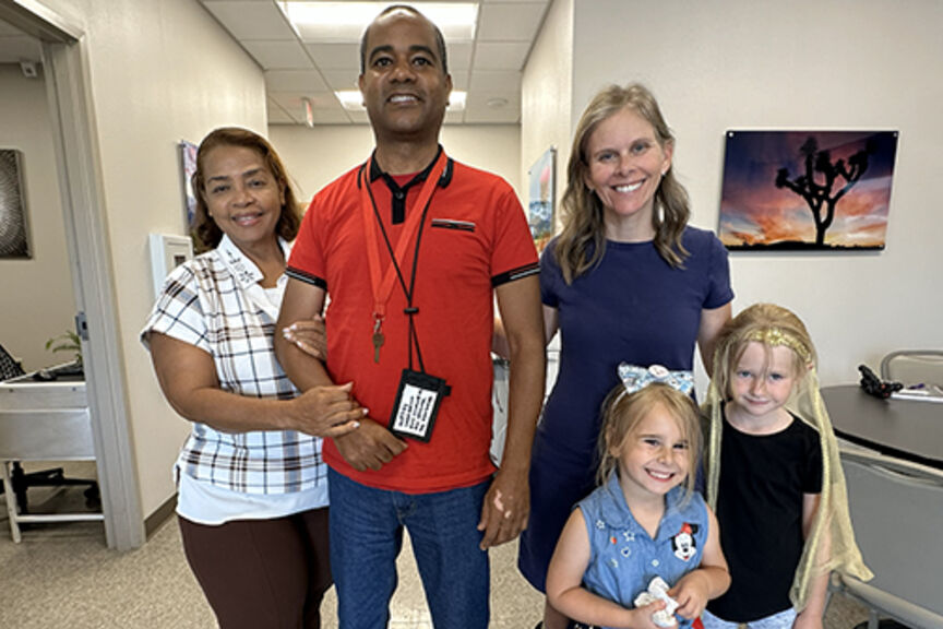 Glexey Caraballo stands with his mother, and Cathy Garrett stands with her daughters. Both Glexey and Cathy performed in STROKESTRA as part of their recovery.