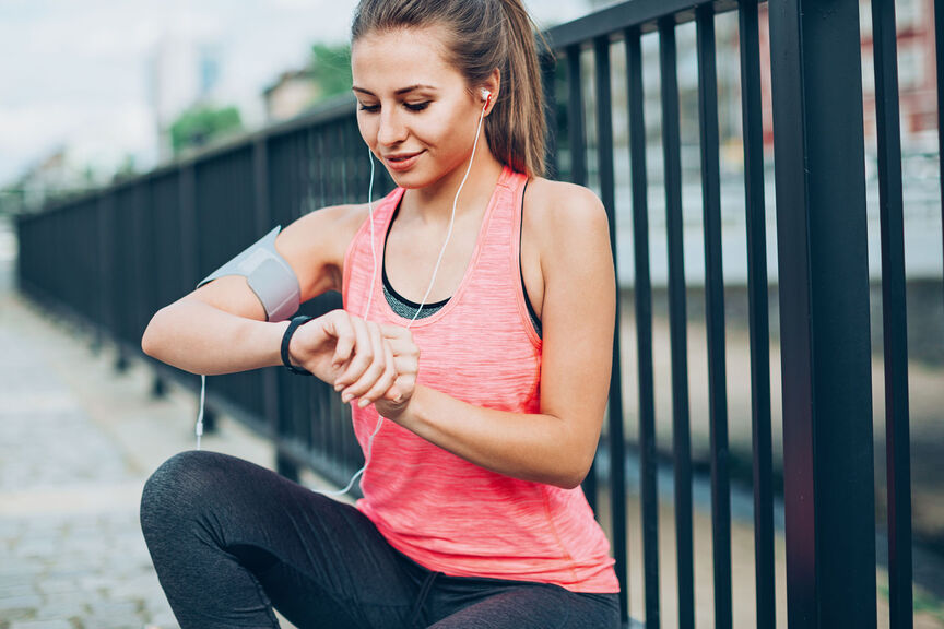 A runner checking her time
