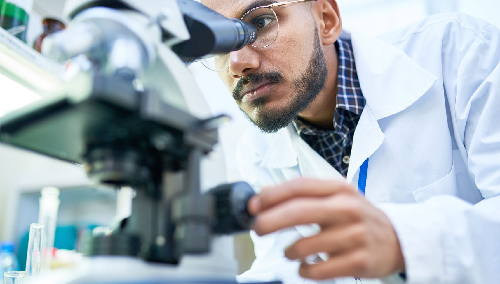 Physician using microscope