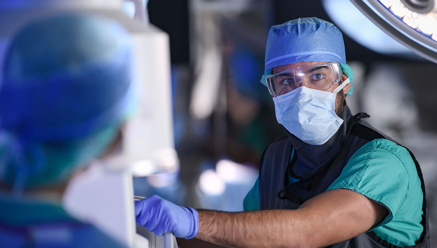 A healthcare worker operating an imaging machine during surgery
