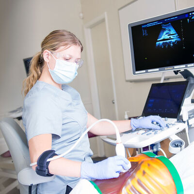 Sonography student practicing scanning skills.