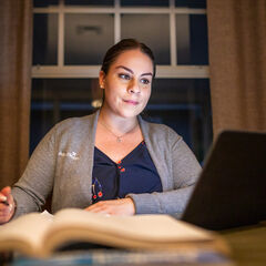 Nurse studying on a laptop