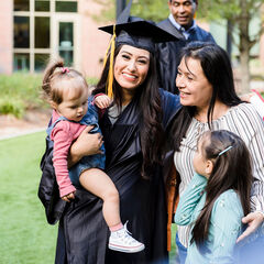 A graduate her family group hugging