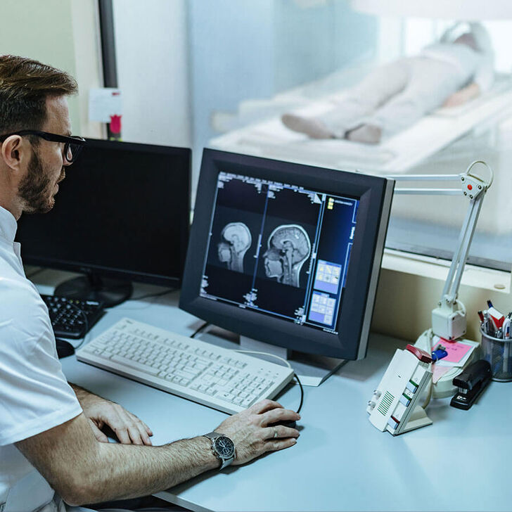 An MRI tech looking at a brain scan