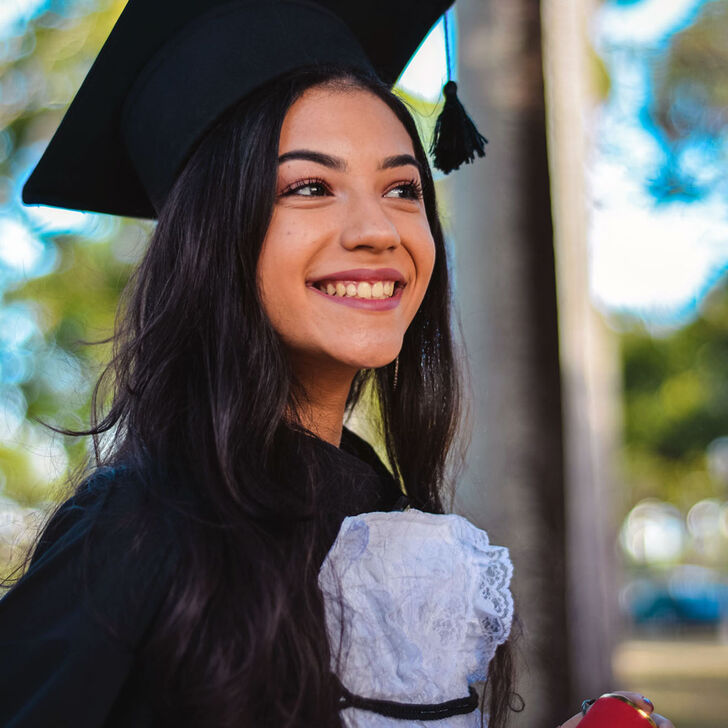 A female student in graduation regalia
