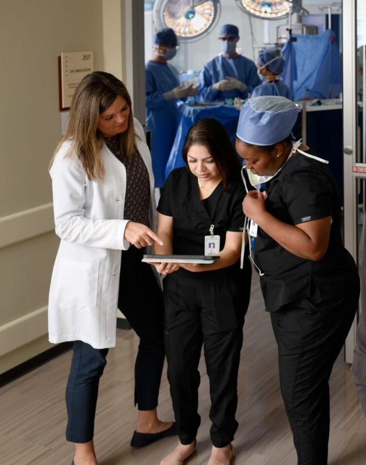 AHU Physicians Assistant Students looking at a tablet