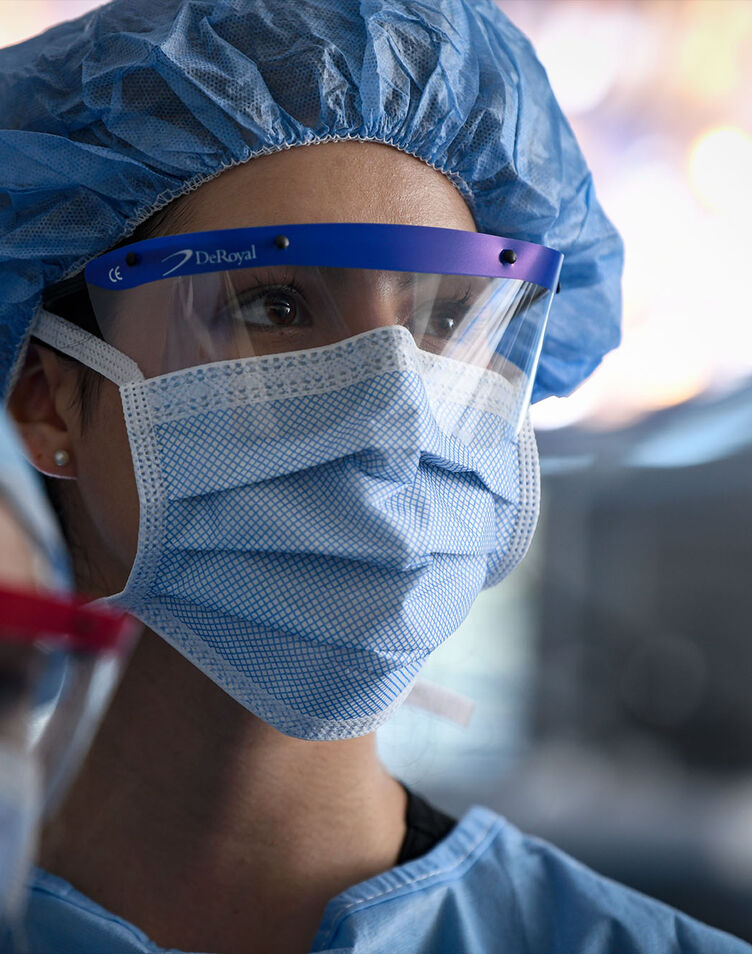 A female physician assistant student dressed in surgical scrubs